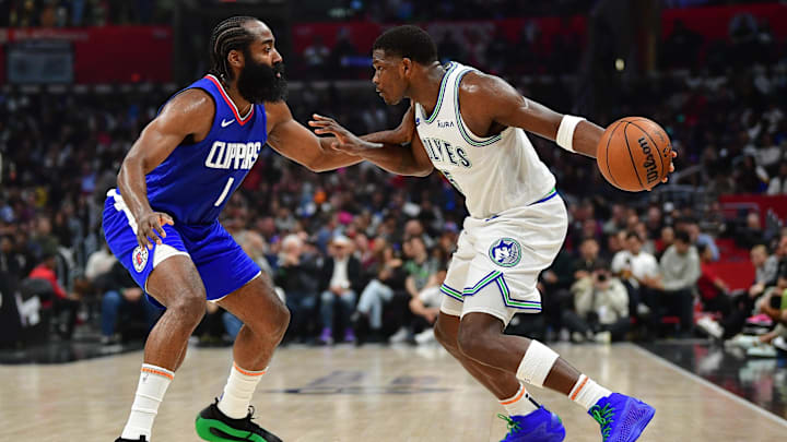 Los Angeles, California, USA; Minnesota Timberwolves guard Anthony Edwards (5) controls the ball against Los Angeles Clippers guard James Harden (1) during the first half at Crypto.com Arena. Mandatory Credit: Gary A. Vasquez-Imagn Images