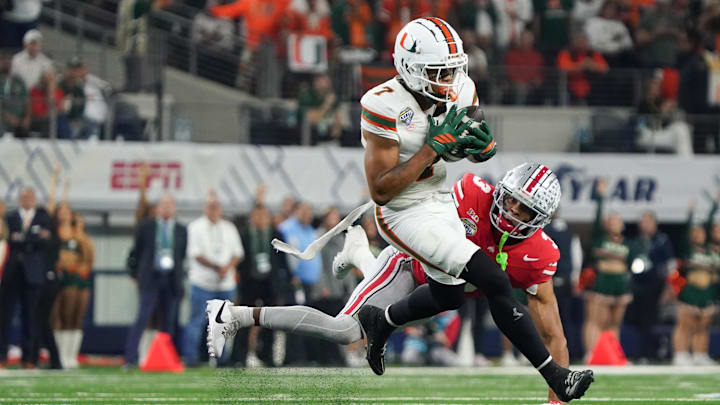 Dec 31, 2025; Arlington, TX, USA; Miami Hurricanes wide receiver CJ Daniels (7) catches while defended by Ohio State Buckeyes cornerback Lorenzo Styles Jr. (3) in the first quarter during the 2025 Cotton Bowl and quarterfinal game of the College Football Playoff at AT&T Stadium. Mandatory Credit: Raymond Carlin III-Imagn Images