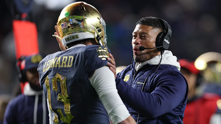 Nov 23, 2024; New York, New York, USA; Notre Dame Fighting Irish head coach Marcus Freeman celebrates with quarterback Riley Leonard (13) after a touchdown during the first half against the Army Black Knights at Yankee Stadium. Mandatory Credit: Vincent Carchietta-Imagn Images