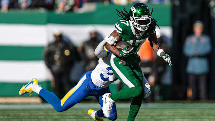 Dec 22, 2024; East Rutherford, New Jersey, USA; New York Jets wide receiver Davante Adams (17) fights for yards as Los Angeles Rams safety Quentin Lake (37) tackles during the first half at MetLife Stadium. Mandatory Credit: Vincent Carchietta-Imagn Images Dec 22, 2024; East Rutherford, New Jersey, USA; New York Jets wide receiver Davante Adams (17) fights for yards as Los Angeles Rams safety Quentin Lake (37) tackles during the first half at MetLife Stadium. Mandatory Credit: Vincent Carchietta-Imagn Images
