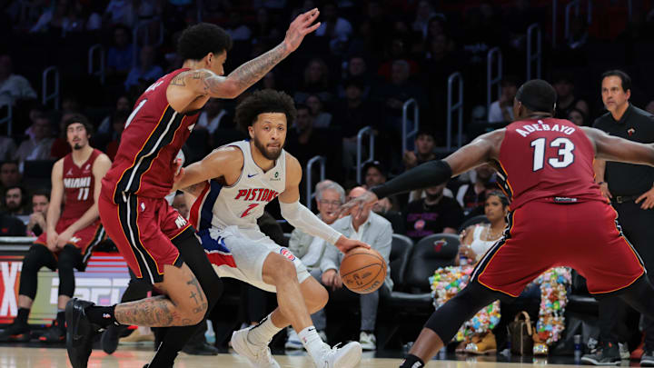 Mar 19, 2025; Miami, Florida, USA; Detroit Pistons guard Cade Cunningham (2) drives to the basket against Miami Heat center Kel'el Ware (7) and center Bam Adebayo (13) during the fourth quarter at Kaseya Center. Mandatory Credit: Sam Navarro-Imagn Images