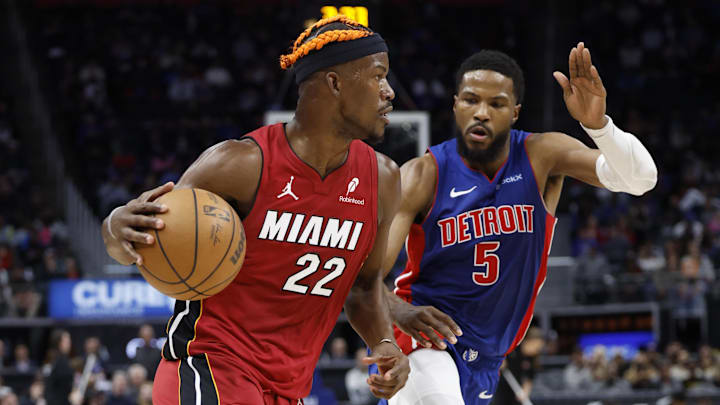Dec 16, 2024; Detroit, Michigan, USA;  Miami Heat forward Jimmy Butler (22) dribbles as Detroit Pistons guard Malik Beasley (5) defends in the first half at Little Caesars Arena. Mandatory Credit: Rick Osentoski-Imagn Images