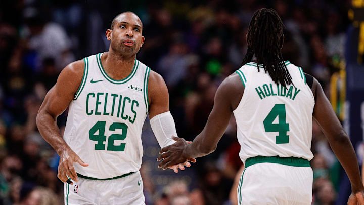 Jan 7, 2025; Denver, Colorado, USA; Boston Celtics center Al Horford (42) and guard Jrue Holiday (4) in the first quarter against the Denver Nuggets at Ball Arena. Mandatory Credit: Isaiah J. Downing-Imagn Images