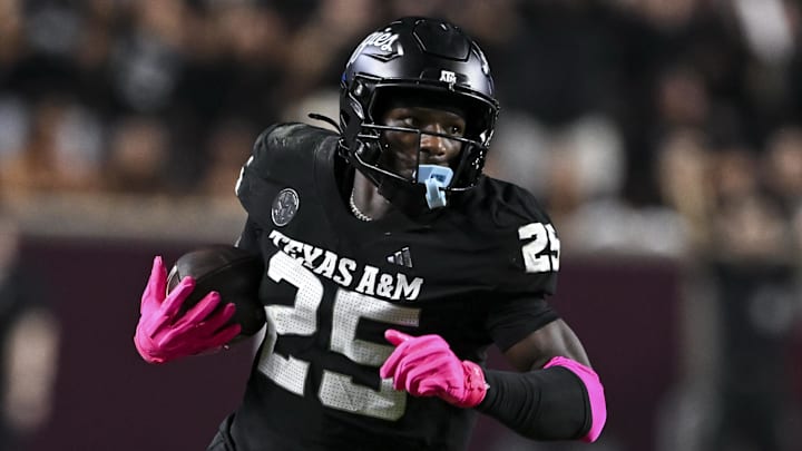 Oct 4, 2025; College Station, Texas, USA; Texas A&M Aggies defensive tackle DJ Hicks (5) runs the ball after a strip sack during the fourth quarter against the Mississippi State Bulldogs at Kyle Field. Mandatory Credit: Maria Lysaker-Imagn Images 