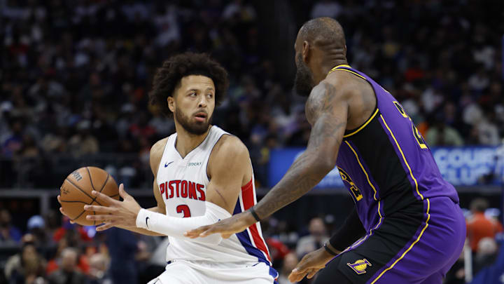 Nov 4, 2024; Detroit, Michigan, USA;  Detroit Pistons guard Cade Cunningham (2) is defended by Los Angeles Lakers forward LeBron James (23) in the second half at Little Caesars Arena. Mandatory Credit: Rick Osentoski-Imagn Images