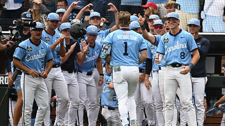 Jun 21, 2026; Omaha, NE, USA; North Carolina Tar Heels third baseman Cooper Nicholson (1) greets teammates after hitting a two-run home run against the Oklahoma Sooners during the seventh inning at Charles Schwab Field. Mandatory Credit: Steven Branscombe-Imagn Images Jun 21, 2026; Omaha, NE, USA; North Carolina Tar Heels third baseman Cooper Nicholson (1) greets teammates after hitting a two-run home run against the Oklahoma Sooners during the seventh inning at Charles Schwab Field. Mandatory Credit: Steven Branscombe-Imagn Images