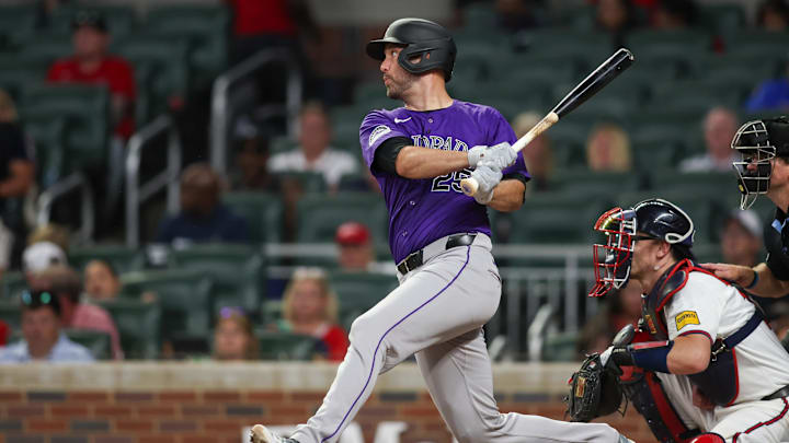 Sep 3, 2024; Atlanta, Georgia, USA; Colorado Rockies catcher Jacob Stallings (25) hits a single against the Atlanta Braves in the seventh inning at Truist Park. Sep 3, 2024; Atlanta, Georgia, USA; Colorado Rockies catcher Jacob Stallings (25) hits a single against the Atlanta Braves in the seventh inning at Truist Park.