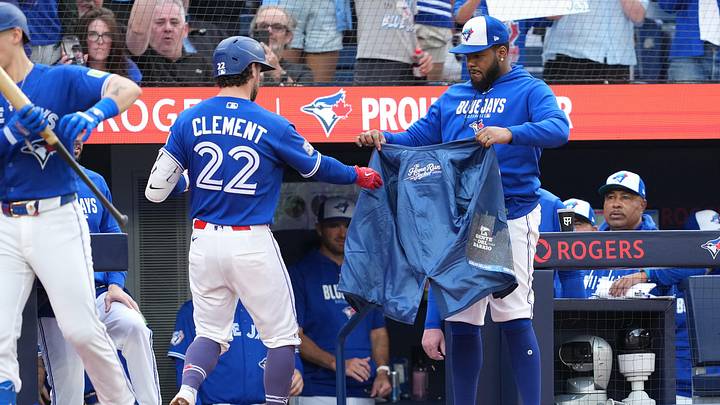 May 26, 2026; Toronto, Ontario, CAN; Toronto Blue Jays second baseman Ernie Clement (22) receives the home run jacket from first baseman Vladimir Guerrero Jr. (27) after hitting a home run against the Miami Marlins during the second inning at the Rogers Centre. 