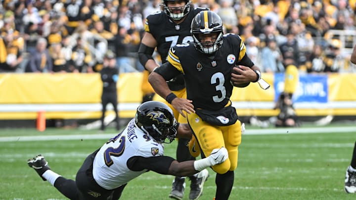 Nov 17, 2024; Pittsburgh, Pennsylvania, USA; Pittsburgh Steelers quarterback Russell Wilson (3) runs away from Baltimore Ravens defensive tackle Nnamdi Madubuike (92) during the second quarter at Acrisure Stadium. Mandatory Credit: Barry Reeger-Imagn Images