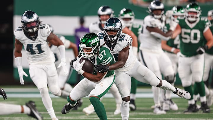 Aug 22, 2025; East Rutherford, New Jersey, USA; New York Jets wide receiver Brandon Smith (87) is tackled by Philadelphia Eagles cornerback Jakorian Bennett (49) during the first half at MetLife Stadium. Mandatory Credit: Vincent Carchietta-Imagn Images