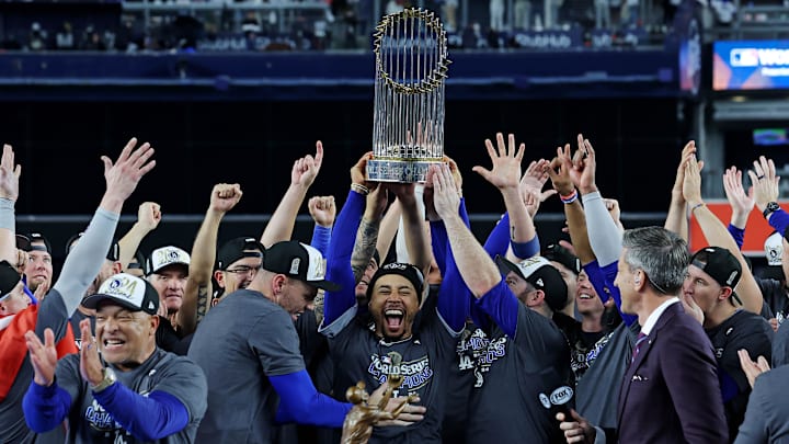 Oct 31, 2024; New York, New York, USA; Los Angeles Dodgers shortstop Mookie Betts (50) celebrates with the Commissioner’s Trophy after the Los Angeles Dodgers beat the New York Yankees in game four to win the 2024 MLB World Series at Yankee Stadium. Mandatory Credit: Brad Penner-Imagn Images