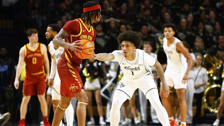 Feb 11, 2025; Orlando, Florida, USA;  Central Florida Knights guard Mikey Williams (1) defends Iowa State Cyclones guard Keshon Gilbert (10) at Addition Financial Arena. Mandatory Credit: Russell Lansford-Imagn Images