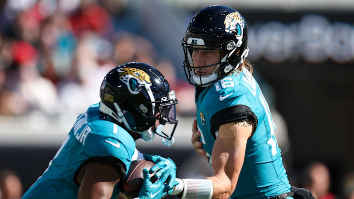 Dec 1, 2024; Jacksonville, Florida, USA; Jacksonville Jaguars quarterback Trevor Lawrence (16) hands off to running back Travis Etienne Jr. (1) against the Houston Texans in the first quarter at EverBank Stadium. Mandatory Credit: Nathan Ray Seebeck-Imagn Images Dec 1, 2024; Jacksonville, Florida, USA; Jacksonville Jaguars quarterback Trevor Lawrence (16) hands off to running back Travis Etienne Jr. (1) against the Houston Texans in the first quarter at EverBank Stadium. Mandatory Credit: Nathan Ray Seebeck-Imagn Images