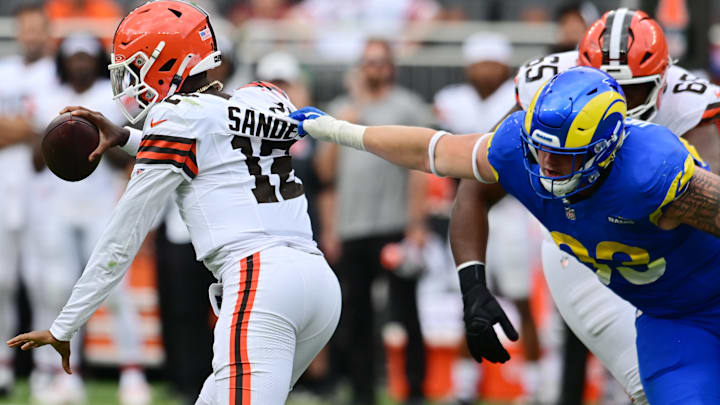 Aug 23, 2025; Cleveland, Ohio, USA; Los Angeles Rams defensive tackle Jack Heflin (93) grabs the jersey of Cleveland Browns quarterback Shedeur Sanders (12) during the second half at Huntington Bank Field. Mandatory Credit: Ken Blaze-Imagn Images Aug 23, 2025; Cleveland, Ohio, USA; Los Angeles Rams defensive tackle Jack Heflin (93) grabs the jersey of Cleveland Browns quarterback Shedeur Sanders (12) during the second half at Huntington Bank Field. Mandatory Credit: Ken Blaze-Imagn Images