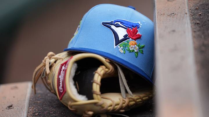 A Toronto Blue Jays hat and glove A Toronto Blue Jays hat and glove