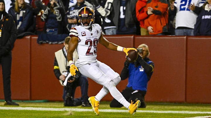 Jan 8, 2023; Landover, Maryland, USA; Washington Commanders cornerback Kendall Fuller (29) returns an interception for a touchdown against the Dallas Cowboys during the first half at FedExField.
