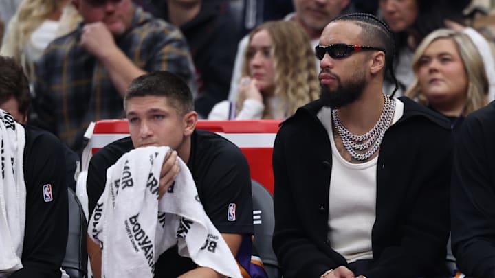 Oct 27, 2025; Salt Lake City, Utah, USA; Phoenix Suns guard Grayson Allen (left) and forward Dillon Brooks (right) watch the game against the Utah Jazz from the bench during the second quarter at Delta Center. Mandatory Credit: Rob Gray-Imagn Images