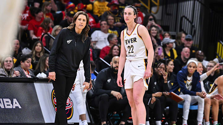 May 4, 2025; Iowa City, IA, USA; Indiana Fever guard Caitlin Clark (22) looks on with head coach Stephanie White during the third quarter against the Brazil National Team at Carver-Haweye Arena. Mandatory Credit: Jeffrey Becker-Imagn Images
