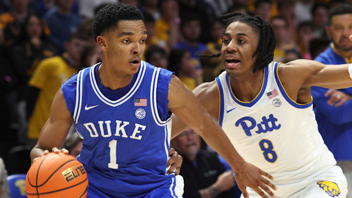 Feb 10, 2026; Pittsburgh, Pennsylvania, USA;  Duke Blue Devils guard Caleb Foster (1) dribbles the ball against Pittsburgh Panthers guard Omari Witherspoon (8) during the first half at Petersen Events Center. Mandatory Credit: Charles LeClaire-Imagn Images