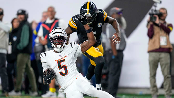 Cincinnati Bengals wide receiver Tee Higgins (5) slides short of the end zone to run time off the clock late in the fourth quarter of the NFL Week 7 game between the Cincinnati Bengals and the Pittsburgh Steelers at Paycor Stadium in downtown Cincinnati on Thursday, Oct. 16, 2025. The Bengals won, 33-31.