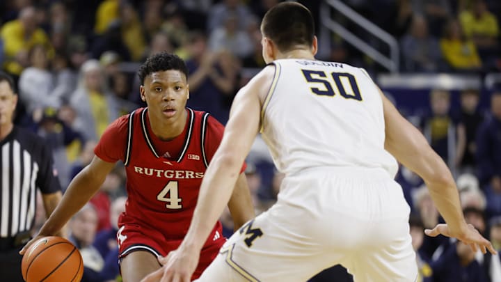 Feb 27, 2025; Ann Arbor, Michigan, USA;  Rutgers Scarlet Knights guard Ace Bailey (4) dribbles defended by Michigan Wolverines center Vladislav Goldin (50) in the second half at Crisler Center. Mandatory Credit: Rick Osentoski-Imagn Images