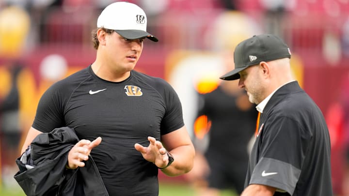 Cincinnati Bengals defensive end Trey Hendrickson (91) talks with director of player personnel Duke Tobin before the first quarter of the NFL Preseason Week 2 game between the Washington Commanders and the Cincinnati Bengals at Northwest Stadium in Landover, Md., on Monday, Aug. 18, 2025.