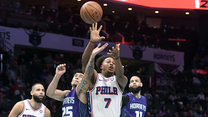Dec 3, 2024; Charlotte, North Carolina, USA;  Charlotte Hornets guard KJ Simpson (25) strips the ball from Philadelphia 76ers guard Kyle Lowry (7) during the second half at the Spectrum Center. Mandatory Credit: Sam Sharpe-Imagn Images