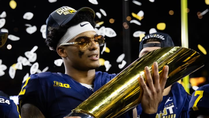 Jan 8, 2024; Houston, TX, USA; Michigan Wolverines defensive back Will Johnson (2) celebrates with the championship trophy after defeating the Washington Huskies during the 2024 College Football Playoff national championship game at NRG Stadium. Mandatory Credit: Mark J. Rebilas-USA TODAY Sports Jan 8, 2024; Houston, TX, USA; Michigan Wolverines defensive back Will Johnson (2) celebrates with the championship trophy after defeating the Washington Huskies during the 2024 College Football Playoff national championship game at NRG Stadium. Mandatory Credit: Mark J. Rebilas-USA TODAY Sports