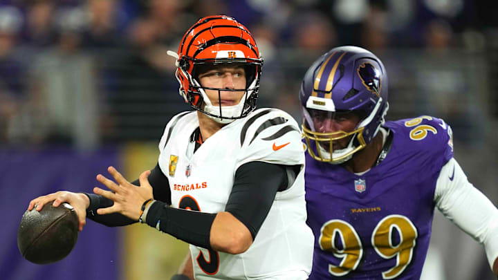 Nov 7, 2024; Baltimore, Maryland, USA; Cincinnati Bengals quarterback Joe Burrow (9) is pressured by Baltimore Ravens linebacker Odafe Oweh (99) during the first quarter at M&T Bank Stadium. Mandatory Credit: Mitch Stringer-Imagn Images