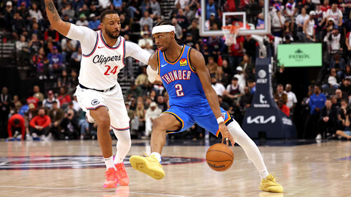 Mar 23, 2025; Inglewood, California, USA; Oklahoma City Thunder guard Shai Gilgeous-Alexander (2) drives against LA Clippers guard Norman Powell (24) during the 4th quarter at Intuit Dome.