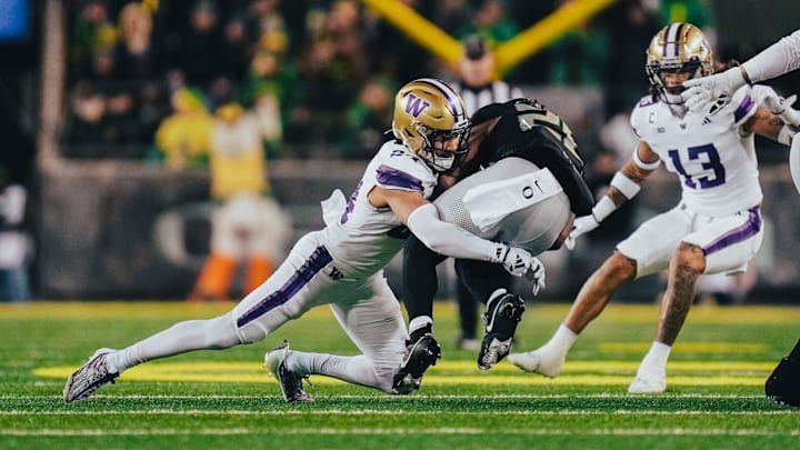 Husky safety Makell Esteen makes a tackle at Oregon.
