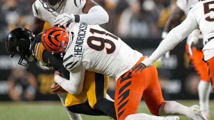 Jan 4, 2025; Pittsburgh, Pennsylvania, USA; Cincinnati Bengals defensive end Trey Hendrickson (91) sacks Pittsburgh Steelers quarterback Russell Wilson (3) in the first quarter at Acrisure Stadium. 