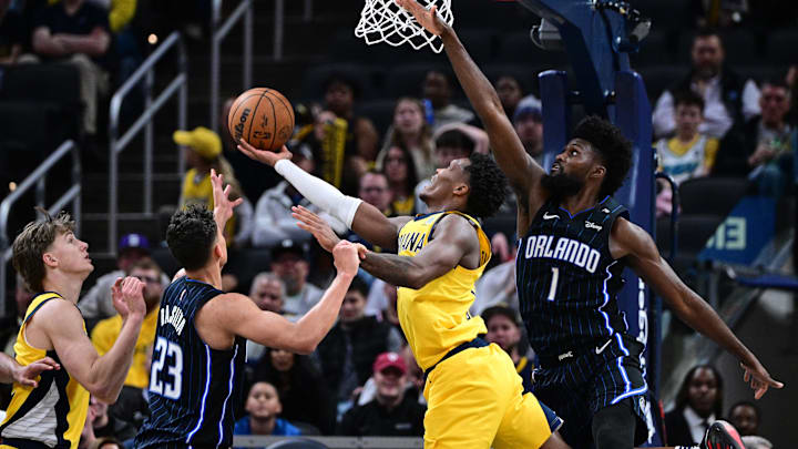 Apr 11, 2025; Indianapolis, Indiana, USA; Indiana Pacers guard Bennedict Mathurin (00) shoots the ball under Orlando Magic forward Jonathan Isaac (1) during the second half at Gainbridge Fieldhouse. Mandatory Credit: Marc Lebryk-Imagn Images Apr 11, 2025; Indianapolis, Indiana, USA; Indiana Pacers guard Bennedict Mathurin (00) shoots the ball under Orlando Magic forward Jonathan Isaac (1) during the second half at Gainbridge Fieldhouse. Mandatory Credit: Marc Lebryk-Imagn Images