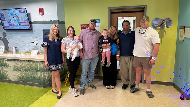 Gavin Marks (far right) with his father (fifth from left to right), mother (fourth), brother (third), sister-in-law (second), and his sister (first) after completing his chemotherapy and beating cancer.