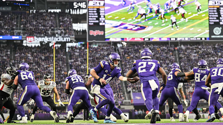 Dec 8, 2024; Minneapolis, Minnesota, USA; Minnesota Vikings quarterback Sam Darnold (14) hands the ball off to running back Cam Akers (27) against the Atlanta Falcons during the fourth quarter at U.S. Bank Stadium. Mandatory Credit: Jeffrey Becker-Imagn Images Dec 8, 2024; Minneapolis, Minnesota, USA; Minnesota Vikings quarterback Sam Darnold (14) hands the ball off to running back Cam Akers (27) against the Atlanta Falcons during the fourth quarter at U.S. Bank Stadium. Mandatory Credit: Jeffrey Becker-Imagn Images