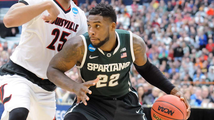 Mar 29, 2015; Syracuse, NY, USA; Michigan State Spartans guard/forward Branden Dawson (22) drives the ball past Louisville Cardinals guard/forward Wayne Blackshear (25) during the second half in the finals of the east regional of the 2015 NCAA Tournament at the Carrier Dome. Mandatory Credit: Mark Konezny-Imagn Images