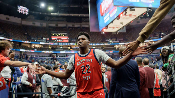 Nov 4, 2025; New Orleans, Louisiana, USA; New Orleans Pelicans center Derik Queen (22) celebrates with fans at the end of the game against the Charlotte Hornets at Smoothie King Center. Mandatory Credit: Matthew Hinton-Imagn Images