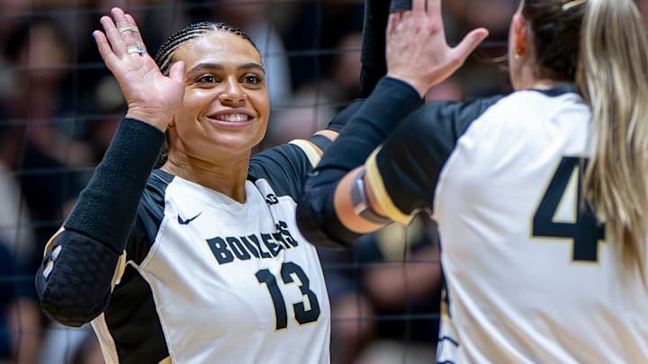 Purdue Senior Akasha Anderson (13) high-fives teammates after a point 