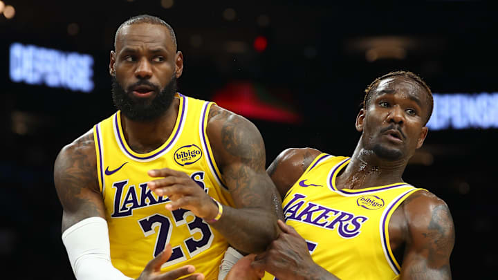 Dec 23, 2025; Phoenix, Arizona, USA; Los Angeles Lakers forward LeBron James (23) and center Deandre Ayton (5) against the Phoenix Suns at Mortgage Matchup Center. Mandatory Credit: Mark J. Rebilas-Imagn Images