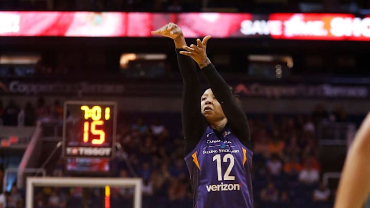 Mercury's Briann January (12) hits a three pointer against Liberty during the first half at Talking Stick Resort Arena in Phoenix, Ariz. on Aug. 19, 2018. 

865709002
