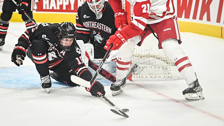 Northeastern forward Jack Williams (15) knocks the puck away from Wisconsin forward Carson Bantle (21) during the first period of the championship game of the Kwik Trip Holiday Face-Off on Friday, December 29, 2023, at Fiserv Forum in Milwaukee, Wisconsin. Northeastern forward Jack Williams (15) knocks the puck away from Wisconsin forward Carson Bantle (21) during the first period of the championship game of the Kwik Trip Holiday Face-Off on Friday, December 29, 2023, at Fiserv Forum in Milwaukee, Wisconsin.