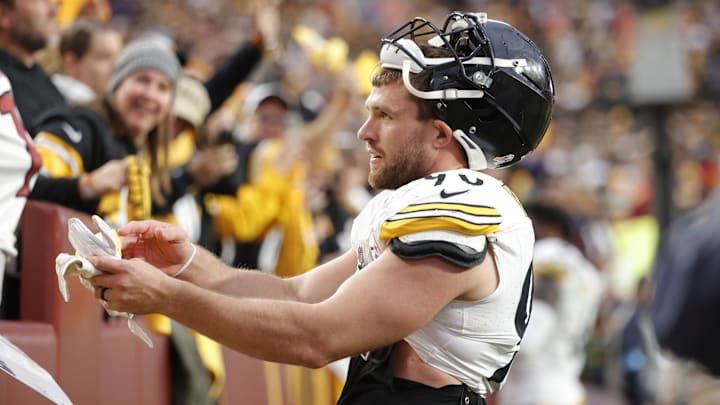 Nov 10, 2024; Landover, Maryland, USA; Pittsburgh Steelers linebacker T.J. Watt (90) gives his gloves to a fan in the stands after defeating the Washington Commanders at Northwest Stadium. Mandatory Credit: Amber Searls-Imagn Images