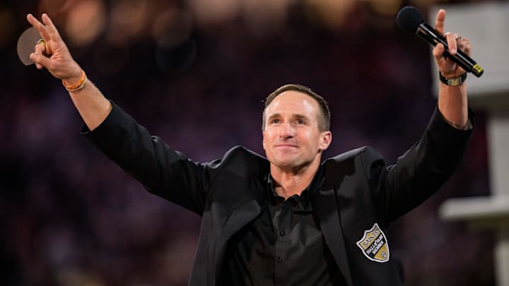 Oct 17, 2024; New Orleans, Louisiana, USA; New Orleans Saints retired quarterback Drew Brees (9) reacts during his hall of fame ceremony at halftime against the Denver Broncos at Caesars Superdome. Mandatory Credit: Matthew Hinton-Imagn Images