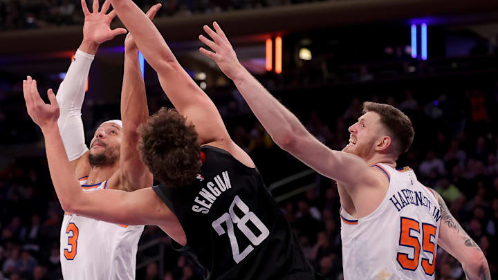 Jan 17, 2024; New York, New York, USA; Houston Rockets center Alperen Sengun (28) fights for a rebound against New York Knicks guard Josh Hart (3) and center Isaiah Hartenstein (55) during the fourth quarter at Madison Square Garden. Mandatory Credit: Brad Penner-Imagn Images