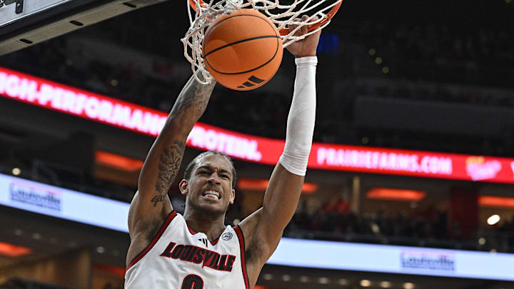 Dec 20, 2025; Louisville, Kentucky, USA;  Louisville Cardinals forward Khani Rooths (9) dunks against Montana Grizzlies guard Grant Kepley (11) during the second half at KFC Yum! Center. Louisville defeated Montana 94-54. Mandatory Credit: Jamie Rhodes-Imagn Images