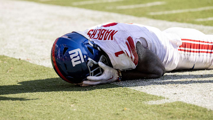 Sep 15, 2024; Landover, Maryland, USA; New York Giants wide receiver Malik Nabers (1) holds his face after dropping a pass against the Washington Commanders in the second half at Commanders Field.  