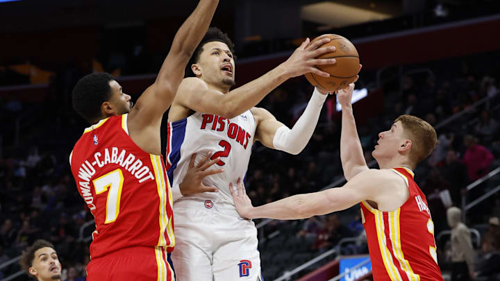 Mar 23, 2022; Detroit, Michigan, USA; (Editors Notes: Caption Correction) Detroit Pistons guard Cade Cunningham (2) goes to the basket against Atlanta Hawks guard Timothe Luwawu-Cabarrot (7) and guard Kevin Huerter (3) in the second half at Little Caesars Arena. Mandatory Credit: Rick Osentoski-Imagn Images