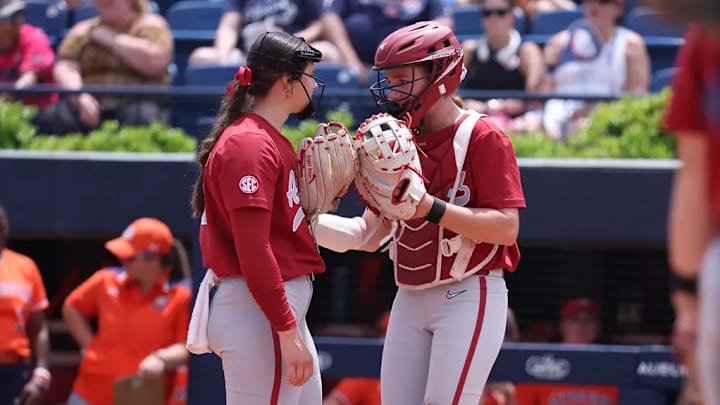 Alabama softball player Alea Johnson (55) and Alabama softball player Marlie Giles meet in the circle at Jane B. Moore Field in Auburn, AL on Saturday, May 4, 2024.