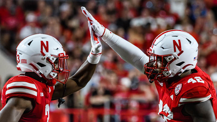 Marques Buford Jr (left) and Mikai Gbayor high-five after a stop on third down. 