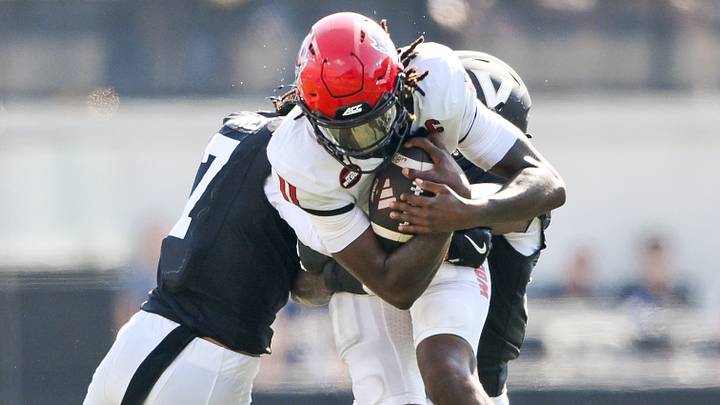Sep 19, 2026; Nashville, Tennessee, USA; NC State Wolfpack quarterback CJ Bailey (11) gets tackled by Vanderbilt Commodores safety Ricardo Jones (7) and safety Jailen Ruth (14) during the second half at FirstBank Stadium. Mandatory Credit: Steve Roberts-Imagn Images Sep 19, 2026; Nashville, Tennessee, USA; NC State Wolfpack quarterback CJ Bailey (11) gets tackled by Vanderbilt Commodores safety Ricardo Jones (7) and safety Jailen Ruth (14) during the second half at FirstBank Stadium. Mandatory Credit: Steve Roberts-Imagn Images